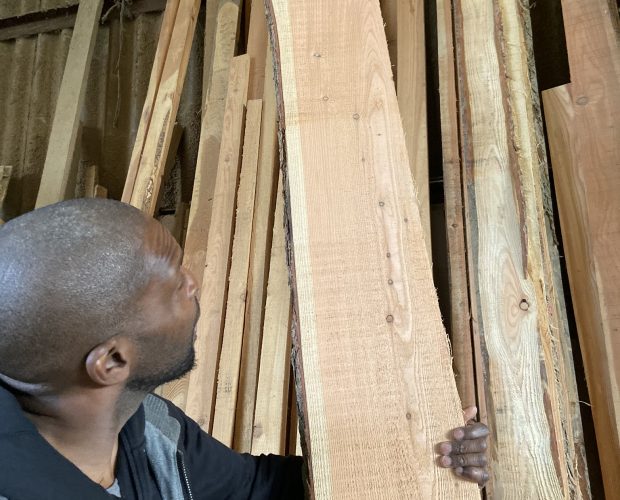 Ikeme looking at wood